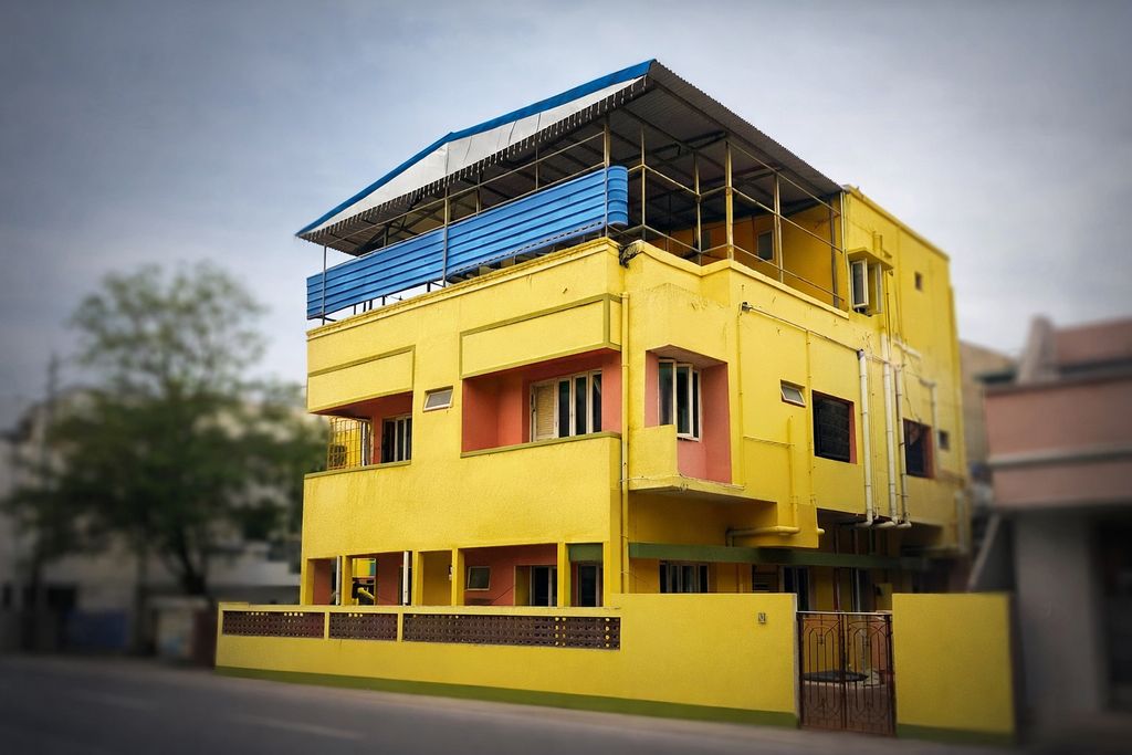 John Bosco Care Home bright yellow three-story building with signage in Ramapuram Chennai
