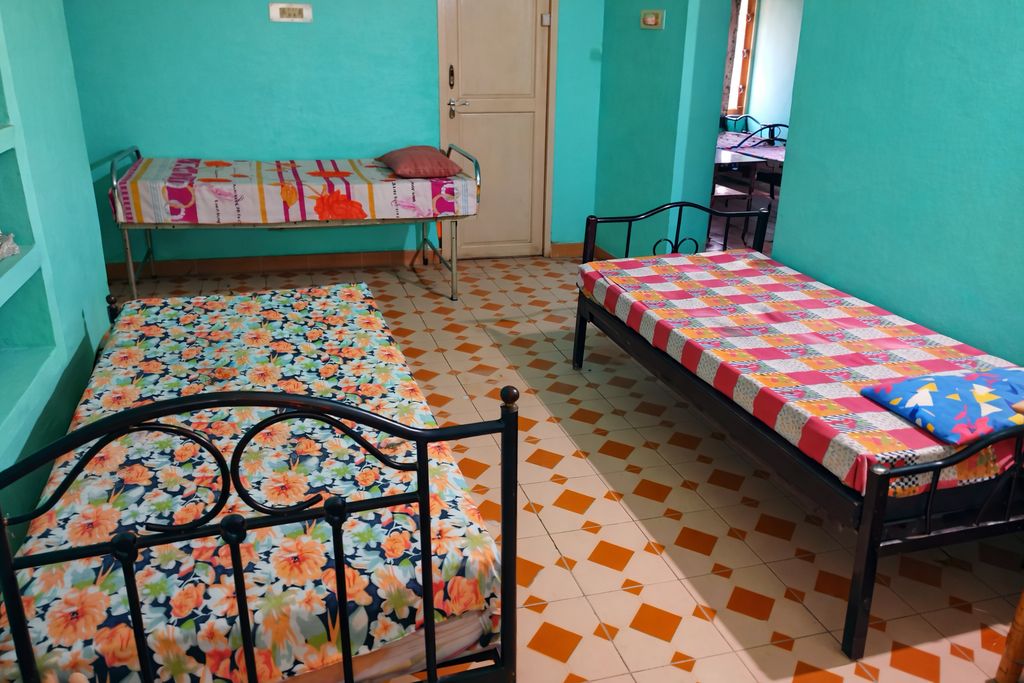 Well-furnished double-occupancy bedroom with individual beds and personal storage