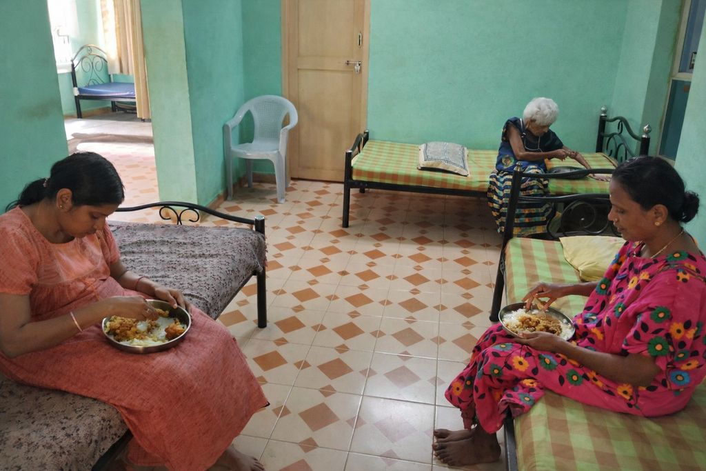 Neat and tidy resident room with hospital-style bed, bedside table, and wardrobe